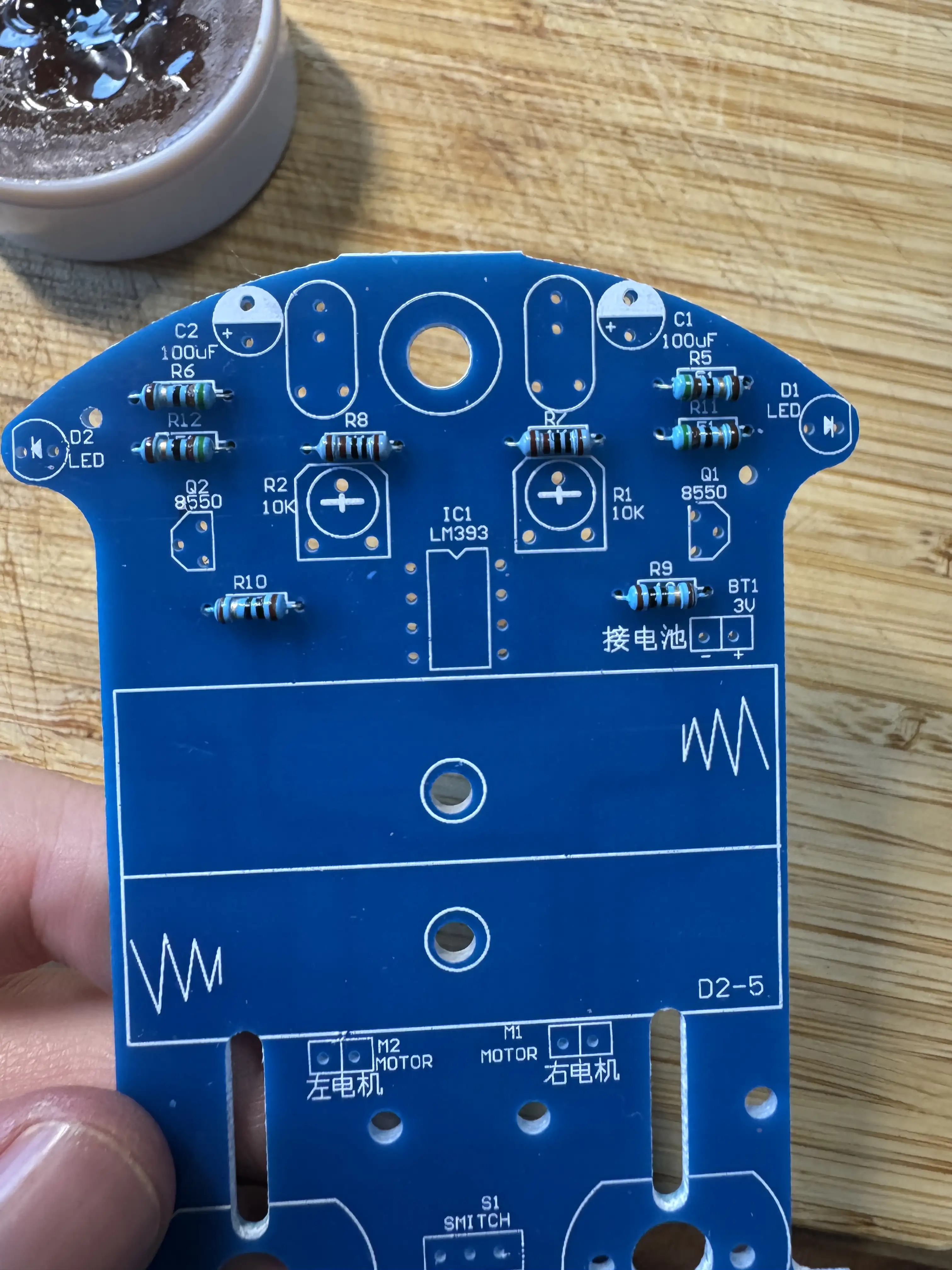 Close-up al plăcii PCB — se vede cipul LM393, R10K, conexiunea bateriei 3 V, motoare M1/M2 marcate în chineză